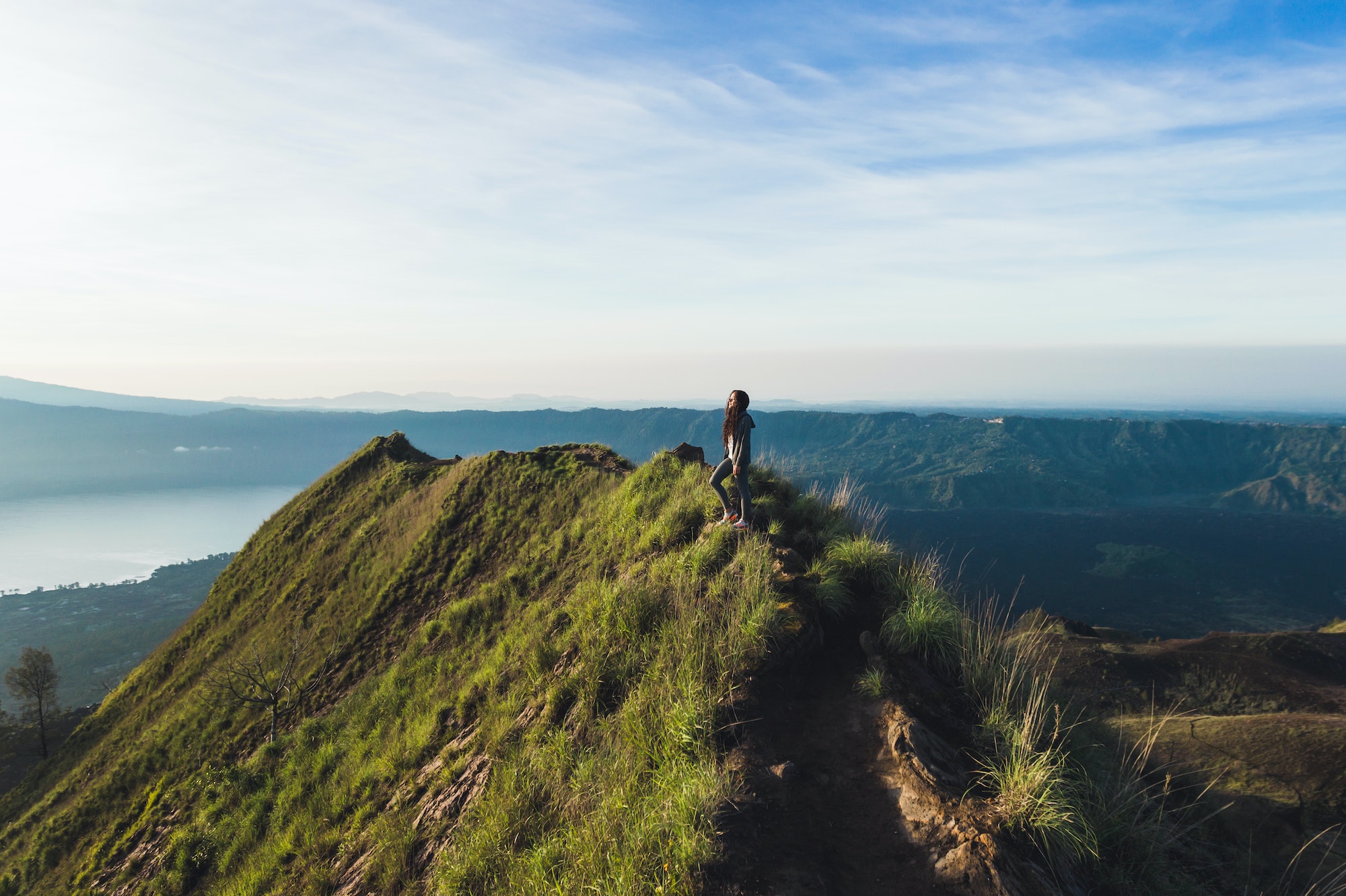 beautiful-woman-at-the-top-of-mount-batur-bali-indonesia-miuntain-hiking-at-sunrise.jpg